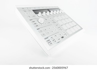 Digital music controller featuring multiple pads, knobs, and buttons for music production and performance, isolated on a clean white background.