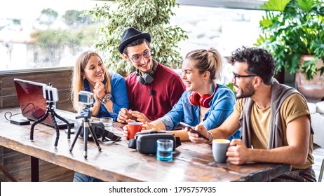 Digital native friends sharing feed on streaming platform with phone and web cam - Content marketing concept with millenial workers having fun vlogging live video on social media space - Bright filter