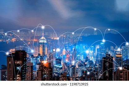 Digital Network Connection Lines Of Hong Kong Downtown And Victoria Harbour. Financial District In Smart City In Technology Concept. Skyscraper And High-rise Buildings. Aerial View At Night.