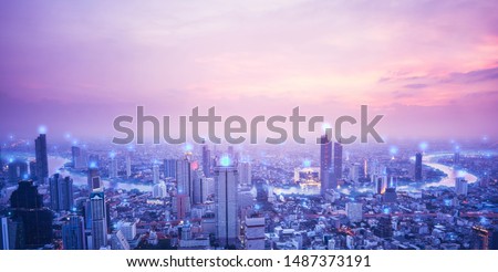 Digital network connection technology concept. Horizon pink sky and blue spot over buliding. Sunset sky river and Bangkok city of Thailand