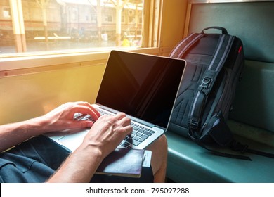 Digital Nomad Man Working On A Laptop In A Train