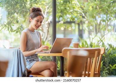 Digital Nomad Millennial Gen X Lifestyle,asian Female Freelance Casual Working From Cafe Working Anywhere Work While Vacation Smiling Hand Type Laptop Cheerful Positive Thinking Work Remotely In Cafe