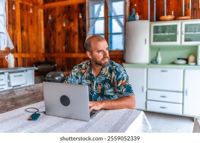 Digital nomad working on laptop in a rustic wooden cabin, embracing the freedom of remote work and enjoying a nomadic lifestyle - Powered by Shutterstock