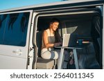 A Digital Nomad Working Remotely Inside a Van While Enjoying Nature with Her Dog