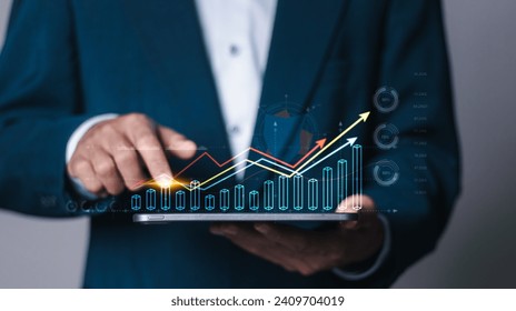 Digital online marketing, Financial and investment business planning and development. Businessman analyzing growth sales data graph on virtual screen. - Powered by Shutterstock