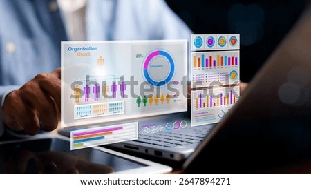 Digital organization chart with team structure, gender distribution pie chart, and colorful data graphs floating over laptop. Concept of business analytics and HR management.