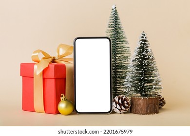 Digital phone mock up with rustic Christmas decorations for app presentation with empty space for you design. Christmas online shopping concept. Tablet with copy space on colored background. - Powered by Shutterstock