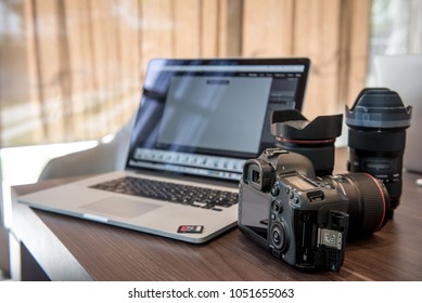 Digital Photography Workstation. Digital DSLR Camera, Laptop Computer.