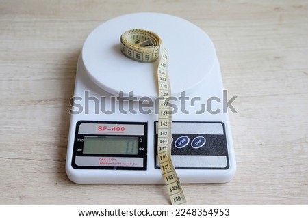 Digital plastic kitchen scale with measuring tape. Electronic scales without measuring cups.