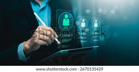 Digital recruitment and candidate selection concept with businessman using stylus to evaluate virtual resume profiles on tablet, symbolizing hiring process, HR technology, employee screening checklist