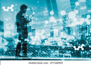 Digital Revolution And Internet Of Things Concept. Double Exposure Of Night City Light And Silhouette Of Business Man Standing And Using Smart Phone With Futuristic Connection Icons. Cool Tone