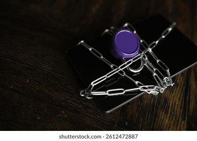 Digital Security Concept: Smartphone Locked with Chain and Padlock on Wooden Surface - Powered by Shutterstock - Get 15% off with code: PIKWIZARD15