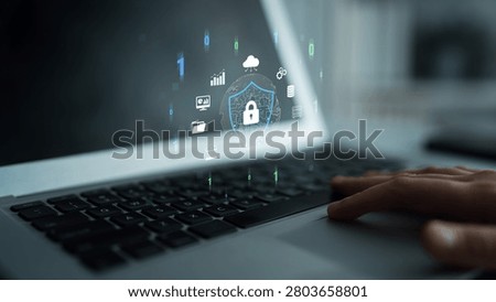 Digital Security and Data Protection Concept with Laptop Interface Displaying Security Icons and Graphs in Modern Workspace Quark.