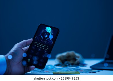 Digital security, featuring smartphone with masked hacker figure on lock screen, surrounded by cash and laptop in dimly lit environment