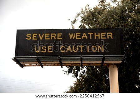 Digital sign at freeway stating Severe Weather Use Caution .  The image is from the 15 freeway in San Diego County California