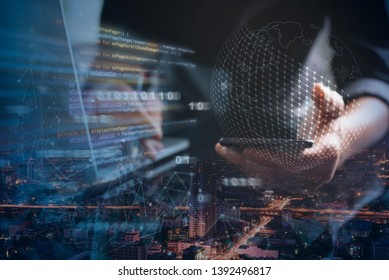 Digital software development concept. Double exposure programmer, software developer coding mobile app on smart phone, laptop and city with  binary, big data, augmented reality computer code