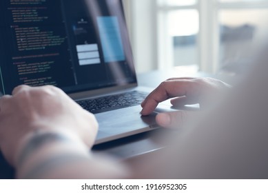 Digital software technology or mobile application development concept. Programmer, software developer coding HTML, program Javascript on laptop computer, UX UI user interface wireframe layout design
