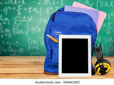 Digital tablet and backpack on the table. - Powered by Shutterstock - Get 15% off with code: PIKWIZARD15
