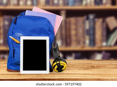 Digital tablet and backpack on the table.