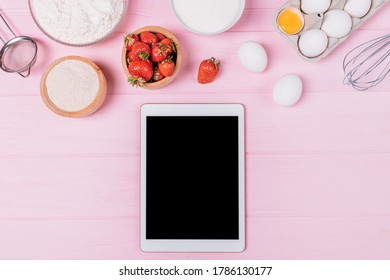 Digital tablet with blank display among ingredients and utensils for baking strawberry pie on pink background. - Powered by Shutterstock