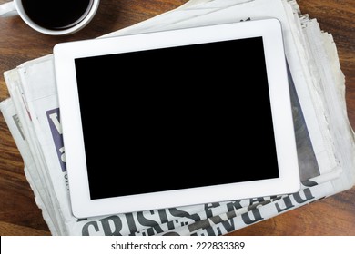 Digital Tablet With Blank Screen On Newspaper Concept For Internet And Electronic News