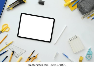 Digital tablet with blank screen and school supplies on white background. Back to school concept - Powered by Shutterstock