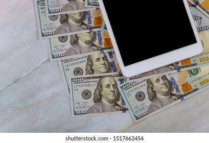 Digital tablet computer with isolated screen in over cash money american dollars in marble background