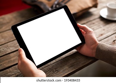 Digital tablet computer with isolated screen in male hands over cafe background - Powered by Shutterstock