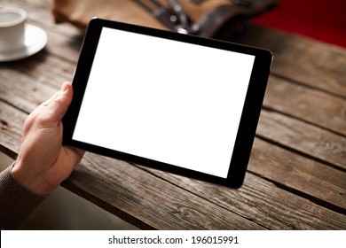 Digital tablet computer with isolated screen in male hands over cafe background - table, cup of coffee... - Powered by Shutterstock