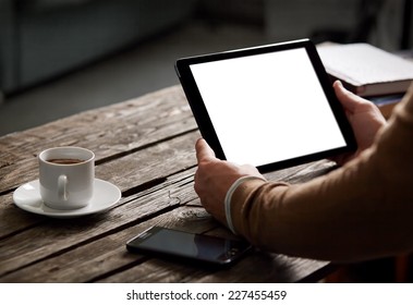 Digital tablet computer with isolated screen in male hands over cafe background - table, smart phone, cup of coffee... - Powered by Shutterstock