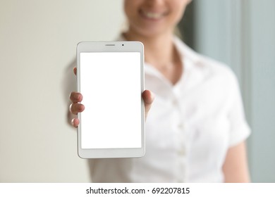 Digital tablet computer mock up display in female hands, woman holding modern gadget with empty blank screen and copy space for advertising product or service, place for your ads, close up view