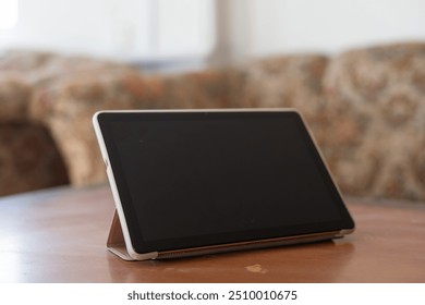 Digital tablet computer on old wooden desk.