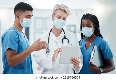 Digital Tablet, Face Mask And Team Of Doctors In Collaboration Doing Covid Research With Technology. Teamwork, Pandemic And Healthcare Workers Consulting On Medicine With A Mobile Device In Hospital.