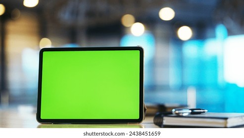 Digital tablet with green screen on the desk in the office - Powered by Shutterstock