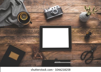 Digital Tablet Ipad, Camera, Tea Cup And A Plant On Wooden Table. Flat Lay. 