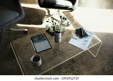 Digital tablet mockup by a vase with white carnation flowers