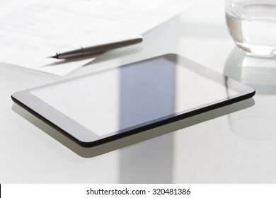 Digital Tablet On Modern Glass Table In Office