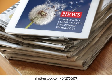 Digital Tablet On Newspaper Concept For Internet And Electronic News