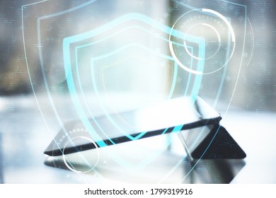 Digital tablet on table and digital system security interface on screen. Business and security concept. Double exposure.