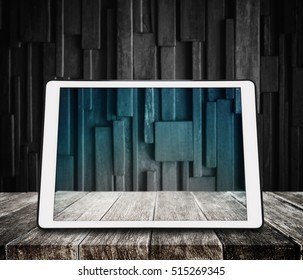 Digital Tablet On Wooden Desk With Dark Wood Background