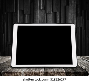 Digital Tablet On Wooden Desk With Dark Wood Background