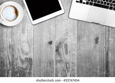 digital tablet pc, computer and cup of coffee on wooden table