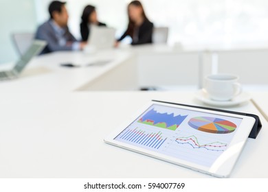 Digital Tablet Showing Data Chart In Meeting Room