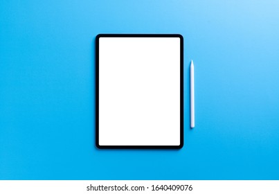 Digital Tablet And Stylus Pen On Light Blue Background