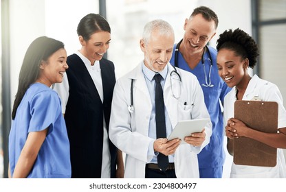 Digital tablet, team and group of healthcare workers in discussion on xrays in medicare clinic. Collaboration, diversity and professional medical employees analyzing a diagnosis on mobile in hospital - Powered by Shutterstock