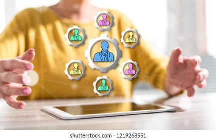 Digital tablet with teamwork concept between hands of a woman in background