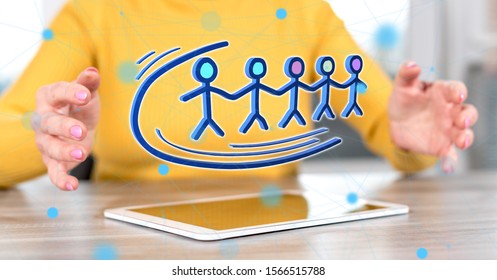 Digital tablet with teamwork concept between hands of a woman in background