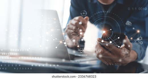 Digital technology, cloud computing concept. Software engineer using mobile smart phone and laptop computer with global network connection, Technology, innovative and communication concept. - Shutterstock ID 2336768323