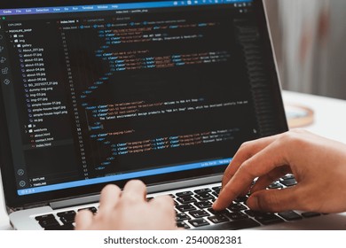 Digital technology, software development concept. Developing programmer, software developer coding computer code on laptop computer. Perfect for coding, IT solutions, applications, coding javascript