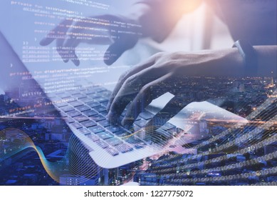 Digital Technology, Software Development, IoT Concept. Double Exposure, Man Programmer, Software Developer Managing Project On Laptop Computer And Smart City With Binary, Big Data And Computer Code